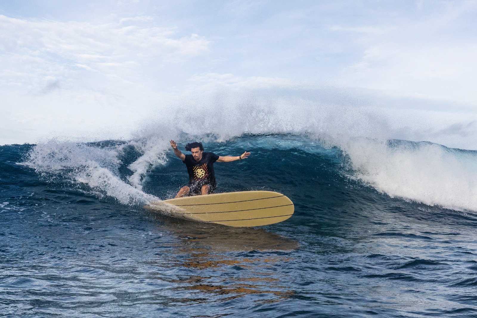 Surfer on Delpero Longboard Classic during cutback